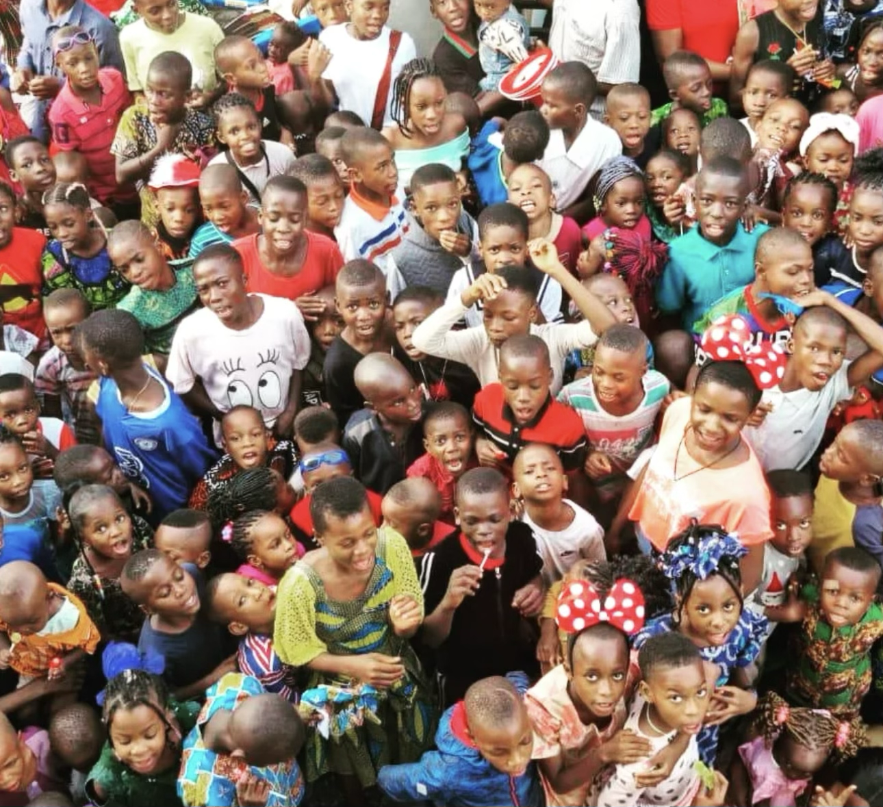 A large crowd of children gathered at a YACT community outreach