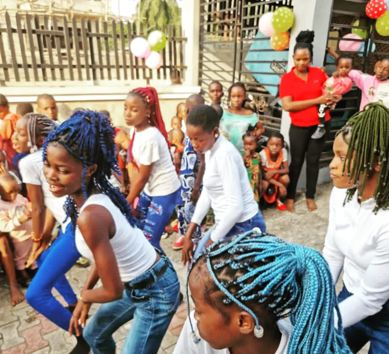 Young people dancing at a YACT community celebration