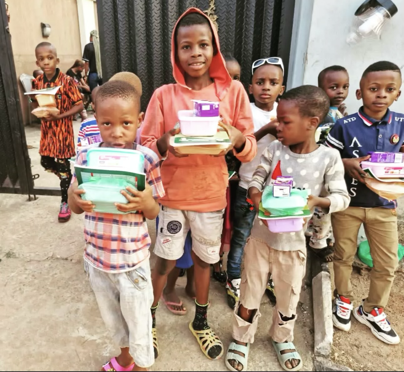 Children receiving books and supplies during a YACT outreach