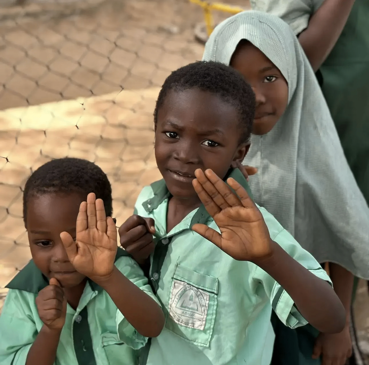 YACT scholars greeting the camera with raised hands