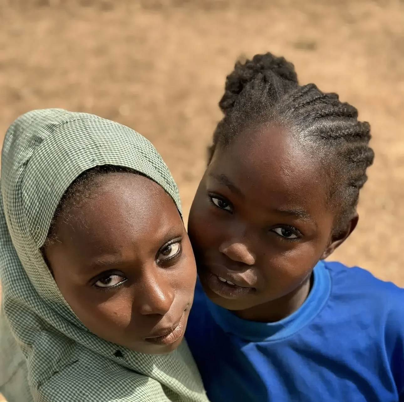 Two young YACT scholars side by side, looking warmly into the camera